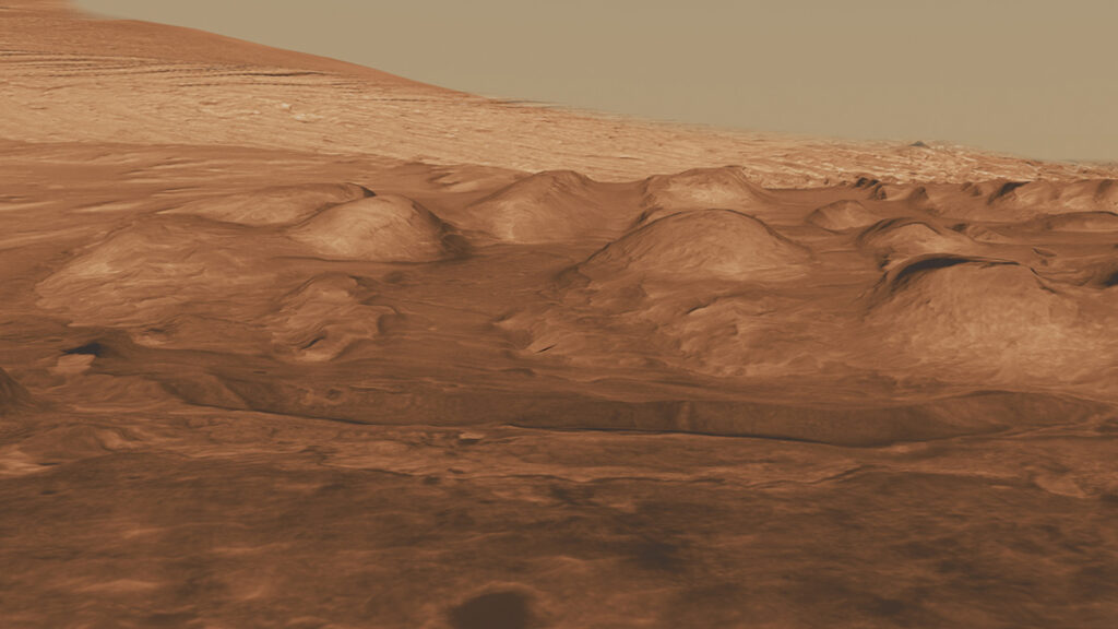 A panoramic view of rocky mounds on a rust-colored Martian landscape