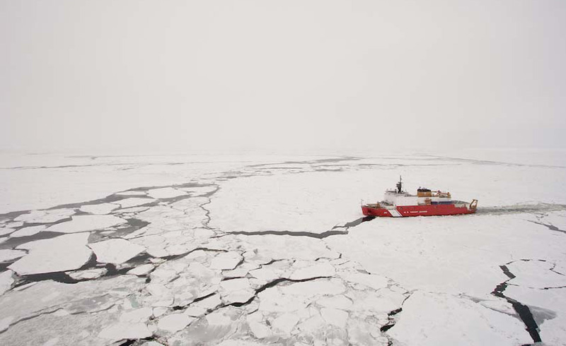 An orange ship in ice-filled waters