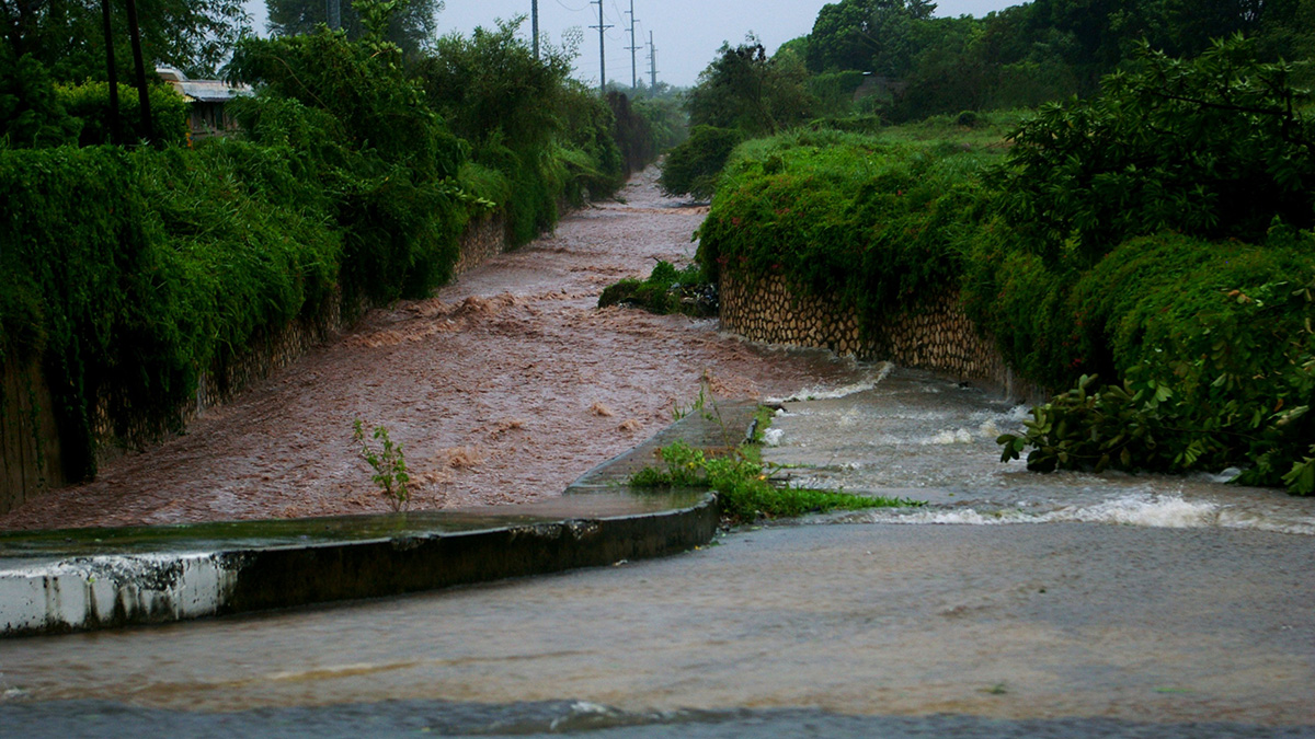 Water flooding and flowing down an empty street
