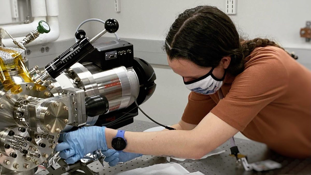 Gloved hands hold a mini Orbitrap cell.