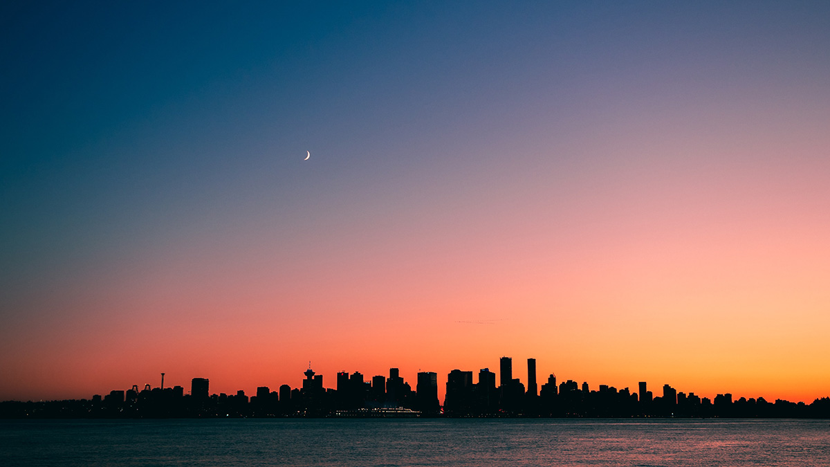 A red-orange glow drapes the Toronto skyline