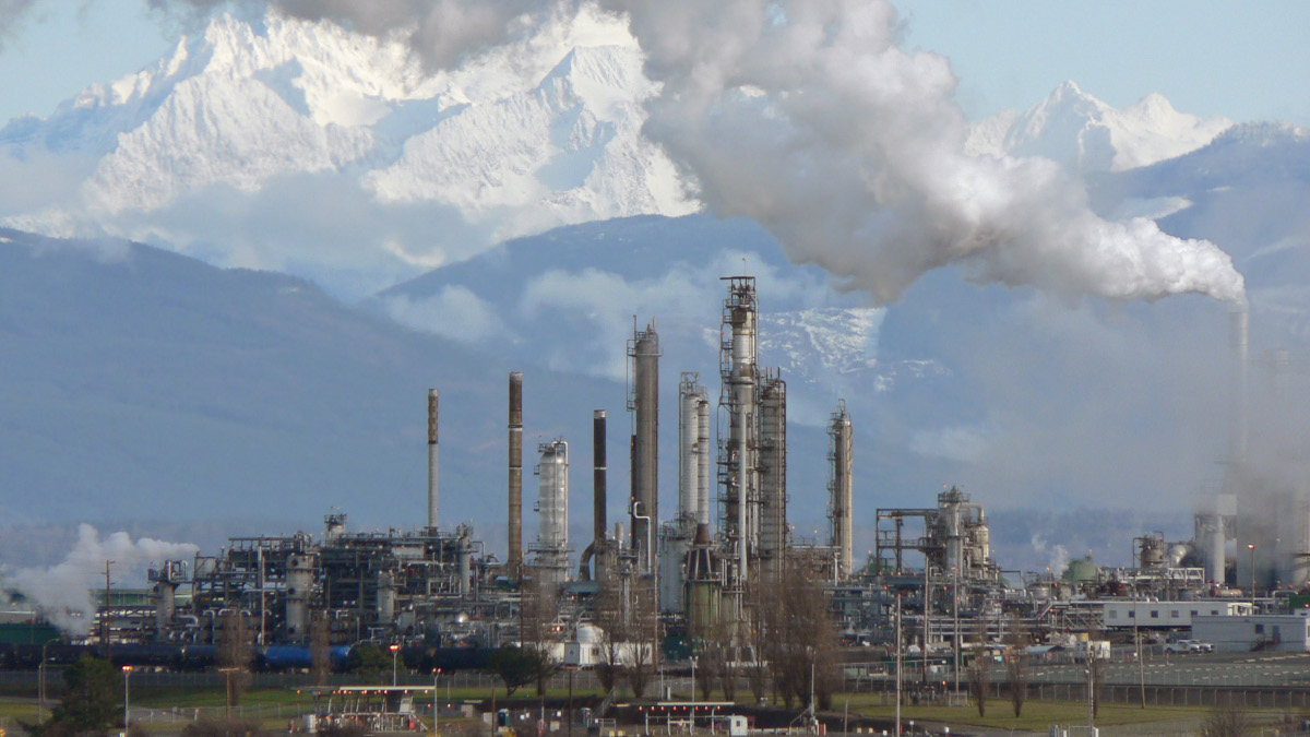 Photograph of a petroleum refinery framed by mountains.