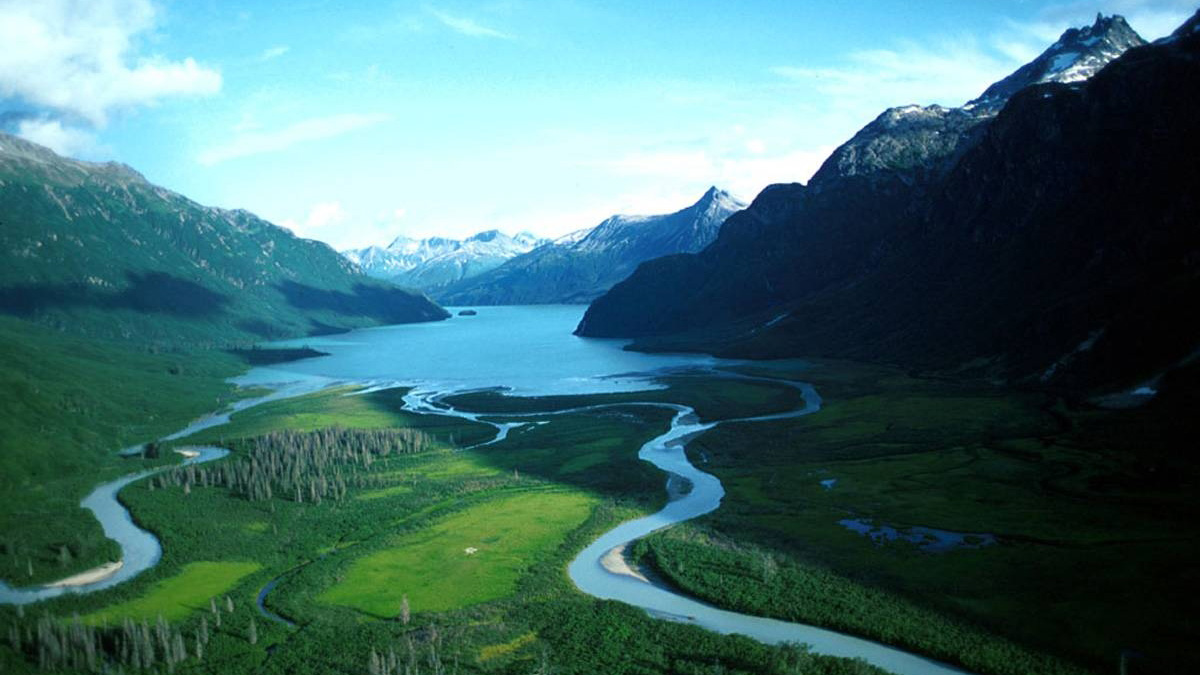 An aerial view of a river flowing in Crescent Lake in Lake Clark National Park