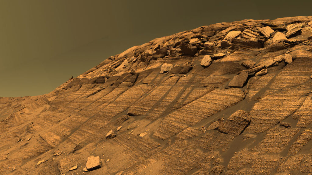 A view of a low cliff on Mars, showing different layers of rocks