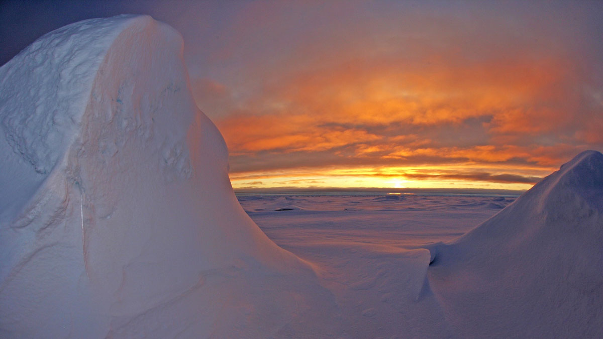 The Sun sets over a thick cover of sea ice in the Arctic.