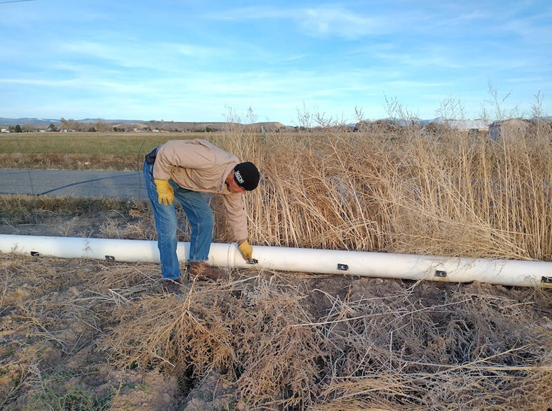 Paul Kehmeier checks a pipe on his farm in Colorado.