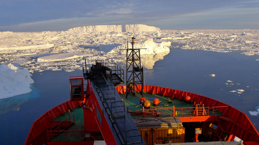 A photo taken from a red ship next to waters with abundant sea ice