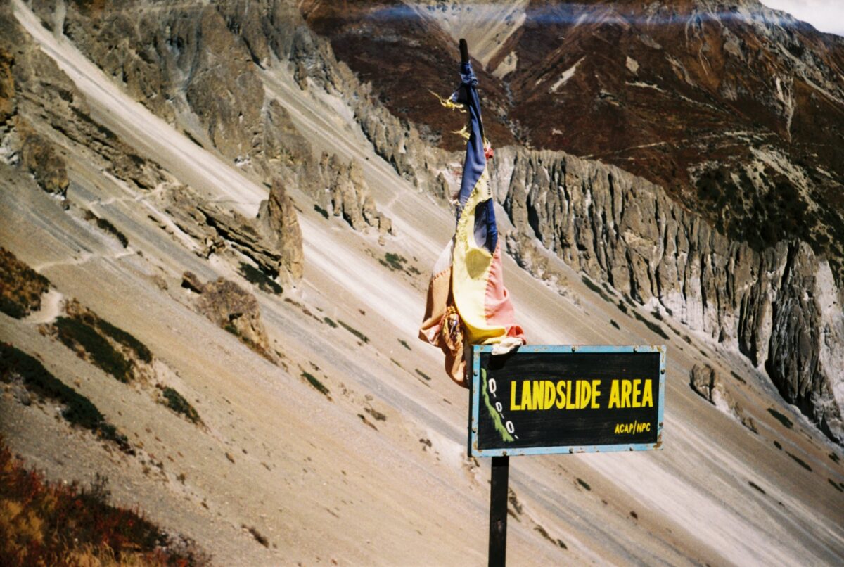 Sign warning of landslide area on the way to Tilicho Lake, Nepal.