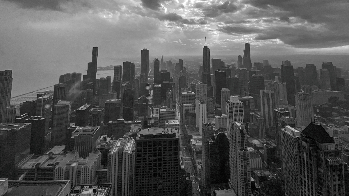 A grayscale image of the Chicago Loop photographed from the 94th floor of the Hancock building.