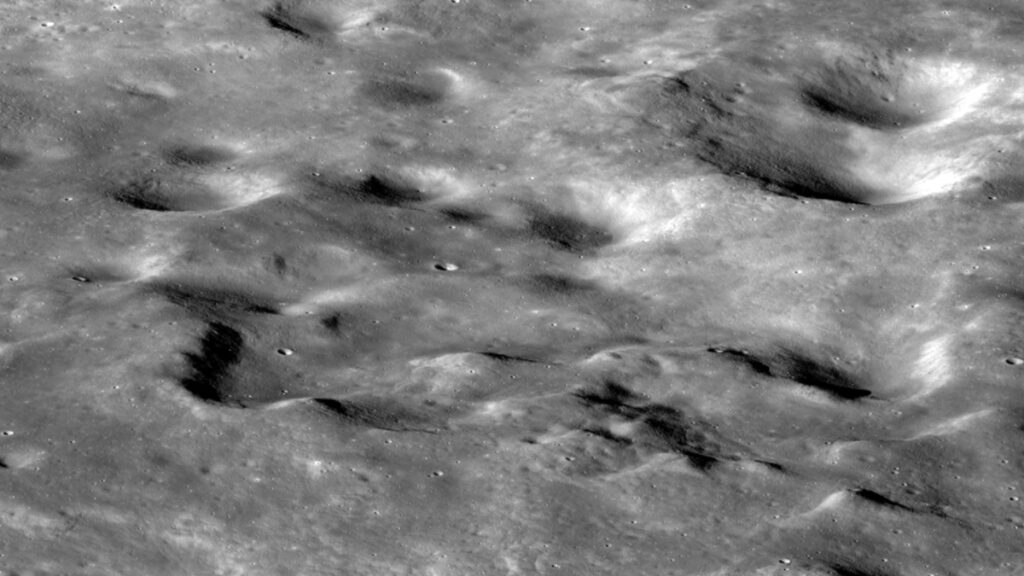 A grayscale image of the Moon’s surface shows bumps, ridges, and craters on the Moon’s farside.