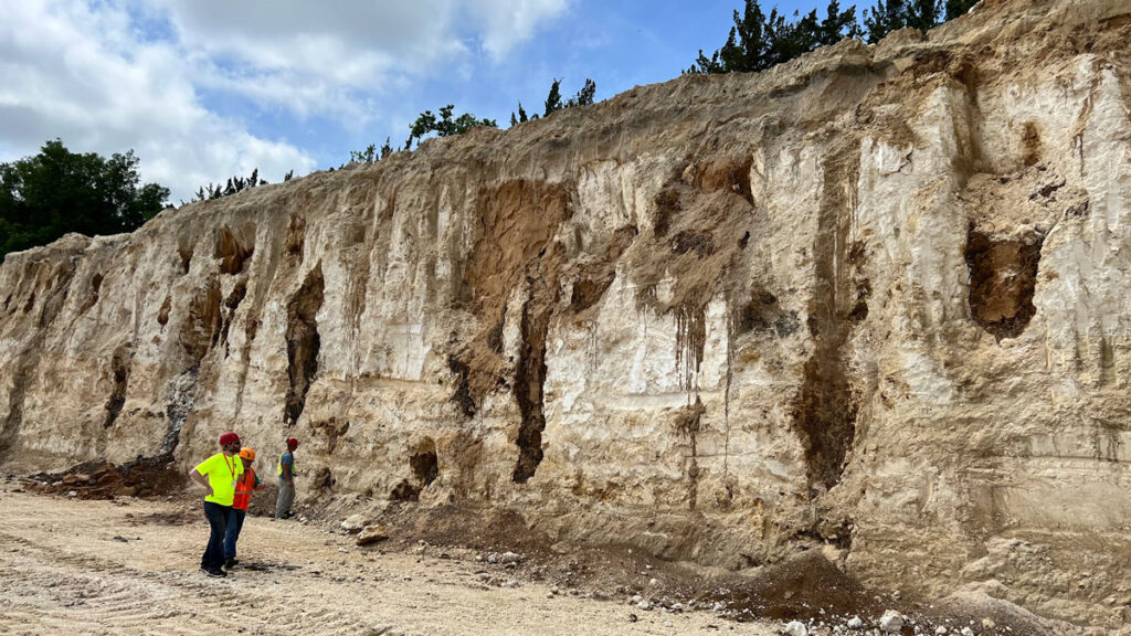 Small sinkholes viewable along the wall of a quarry