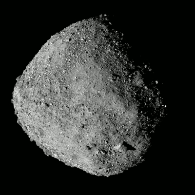 Gray image of a rugged, diamond-shaped asteroid