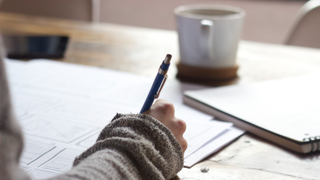 Photo of a person writing.