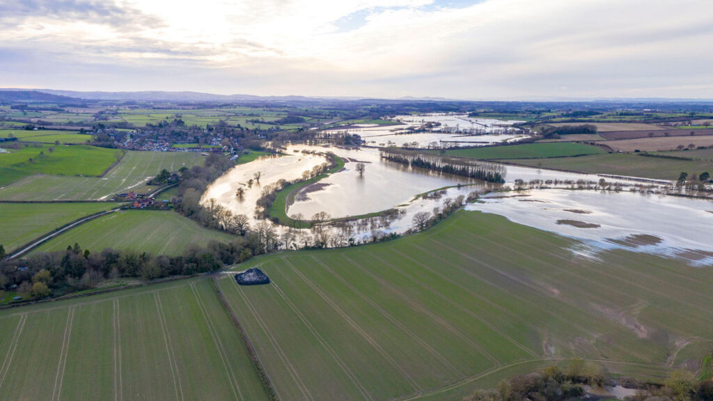 A winding river is overflowing its banks.
