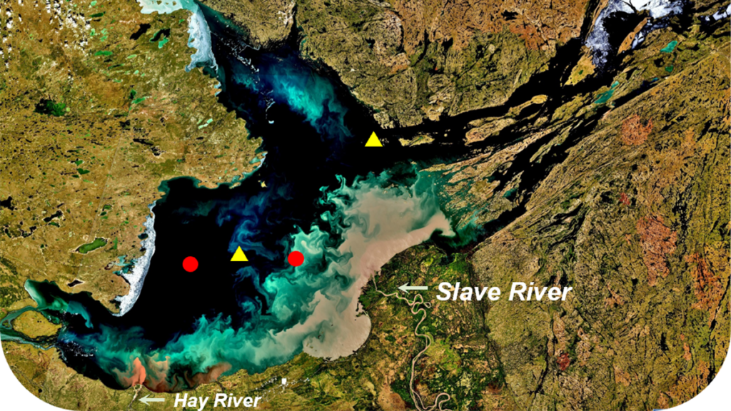 A large, goose-shaped lake stretches across Canada’s Northwest Territories. Two red circles and two yellow triangles mark sites where samples were taken from the lake, and the Slave River and the Hay River are both labeled.