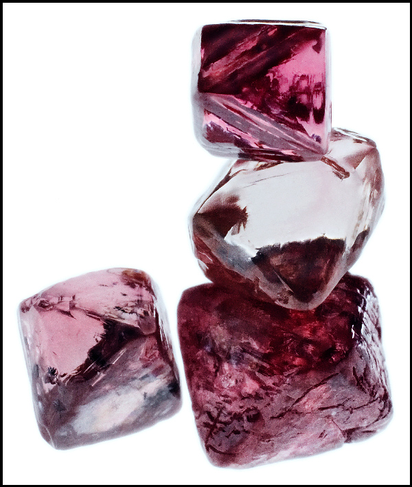 A close-up view of four pink diamonds