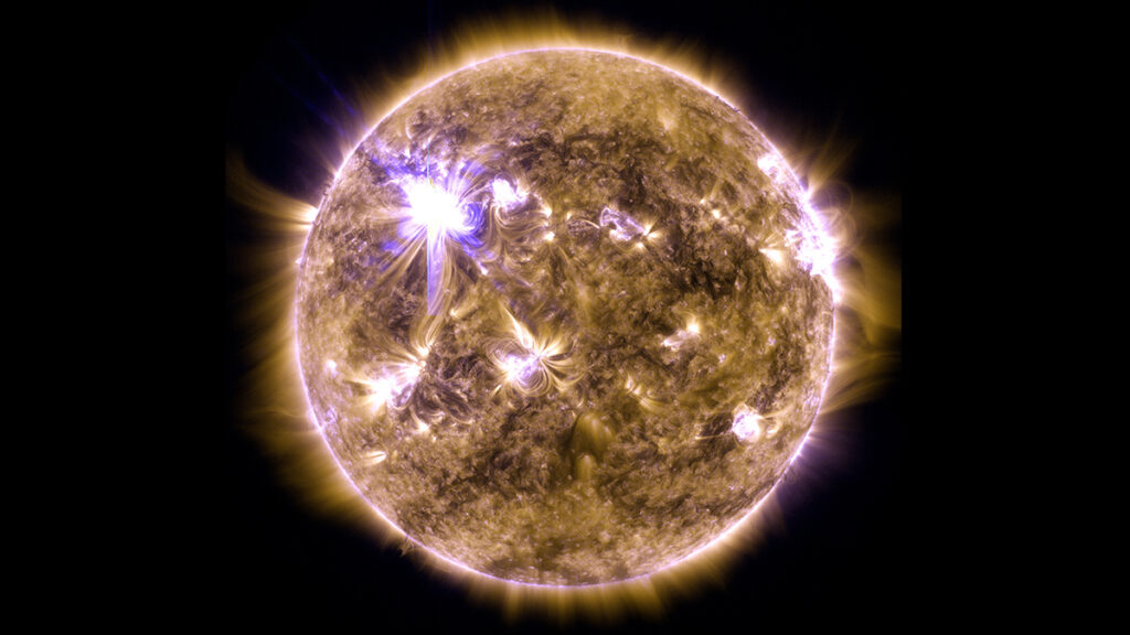 An image of the Sun in ultraviolet wavelengths shows a large solar flare occurring.