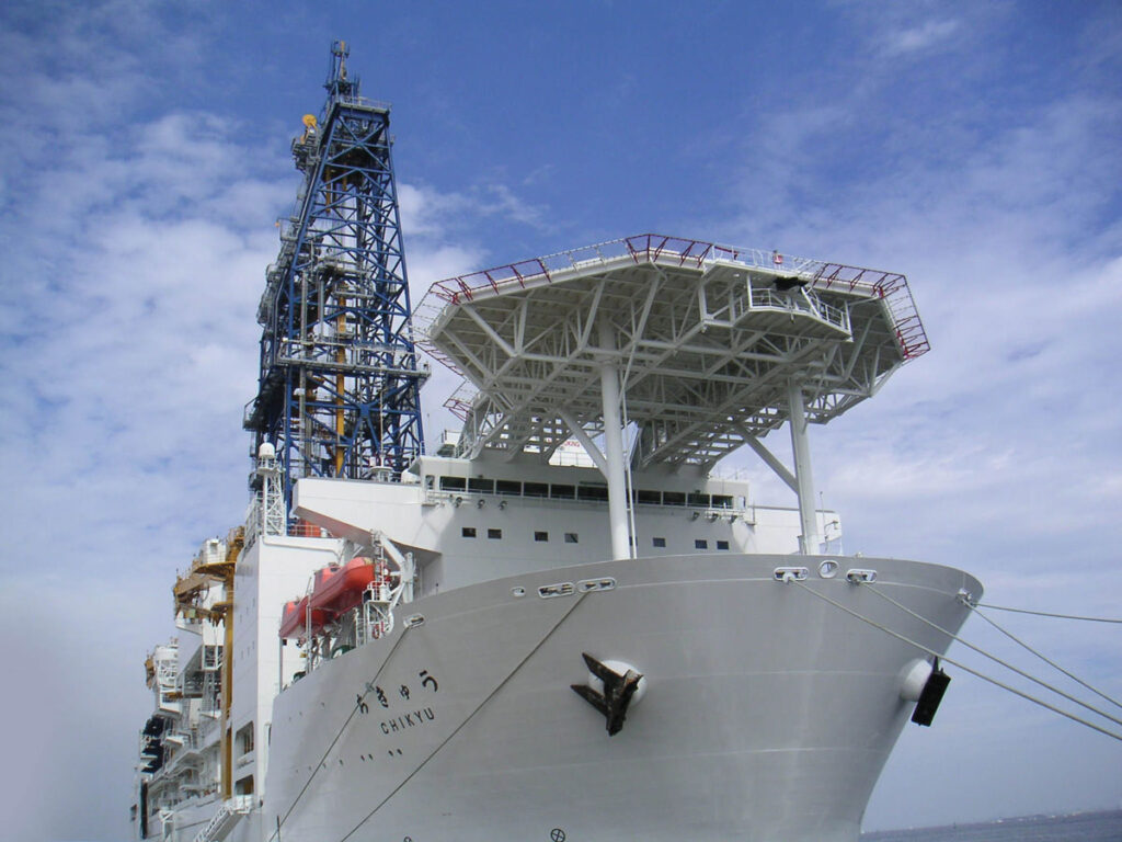 A large white ship, the Chikyu, in port.