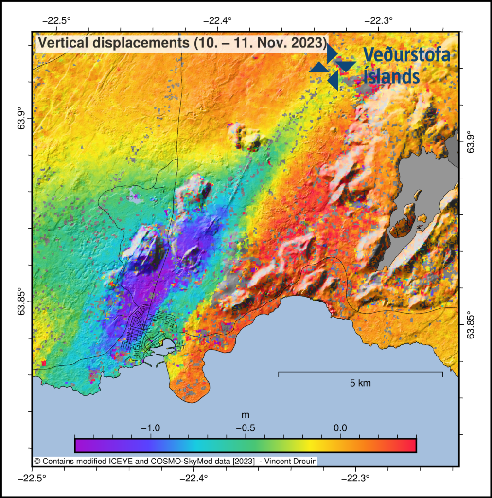 A rainbow-colored map with satellite data shows sinking ground to the west of Grindavík and upwelling to the east of the city.
