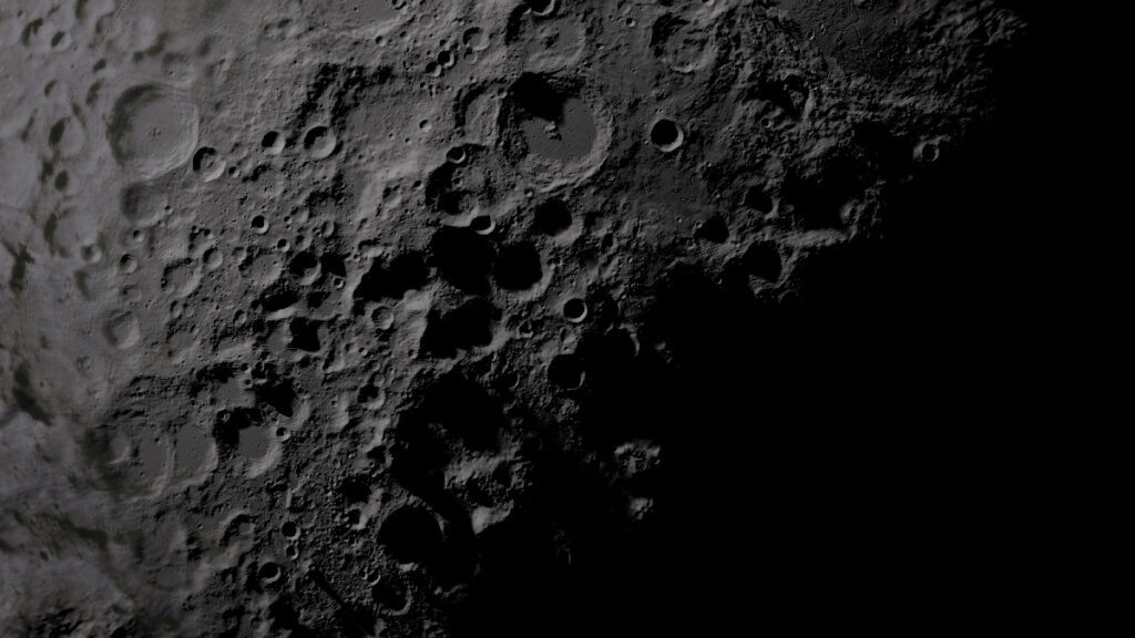 An image of the Moon’s surface at its south pole, half in shadow