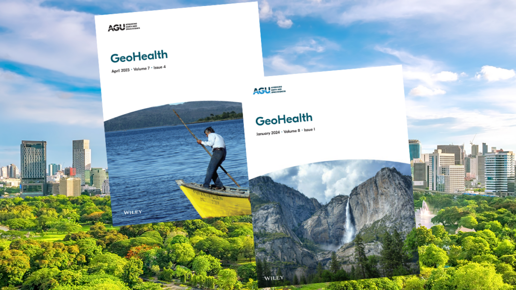 Two GeoHealth journal covers in front of a green park with a city in the background.