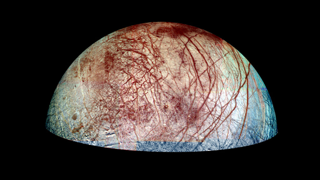 An image of Jupiter’s moon Europa that shows its surface geology: a white surface with brown streaks.