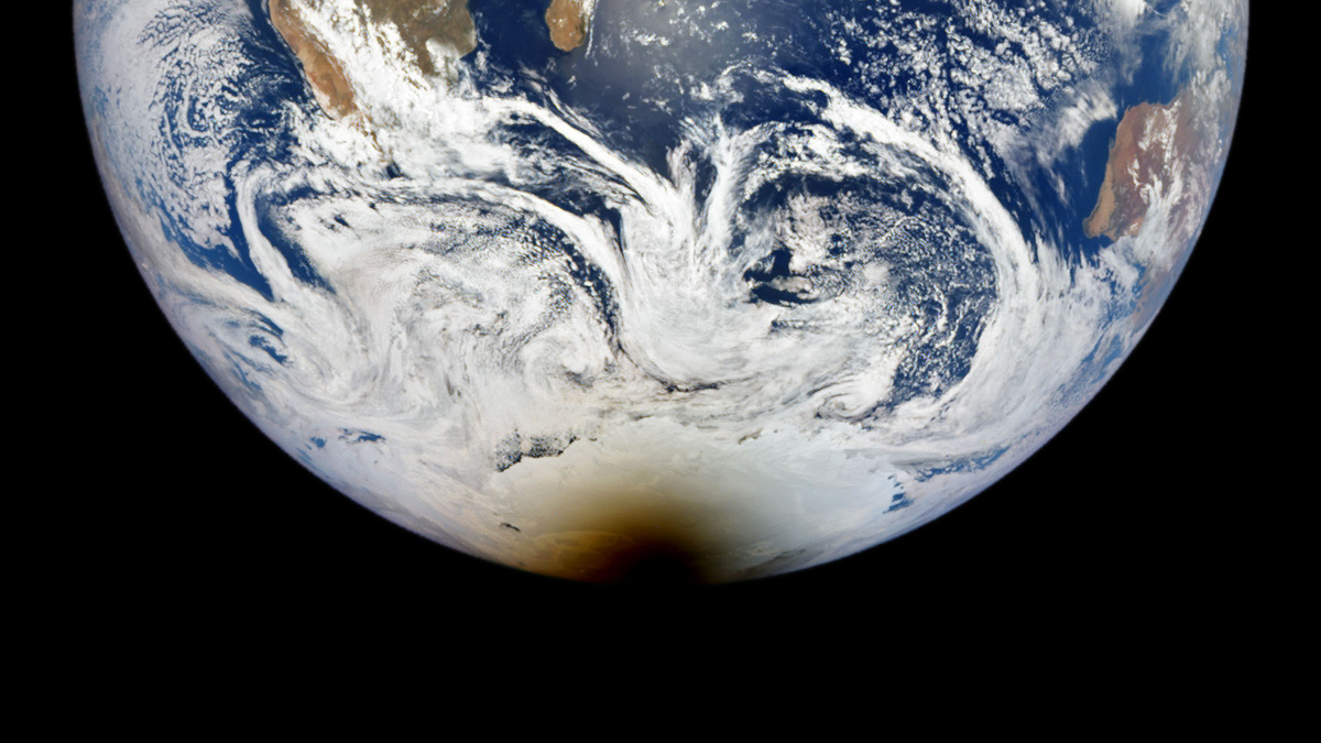 Satellite photo of Earth with a large shadow covering Antarctica.