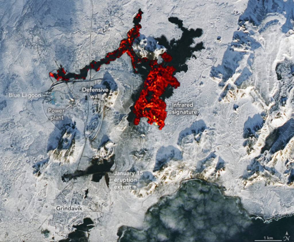 Aerial observations of a town surrounded by snow, ice, cooled lava, and glowing hot lava.