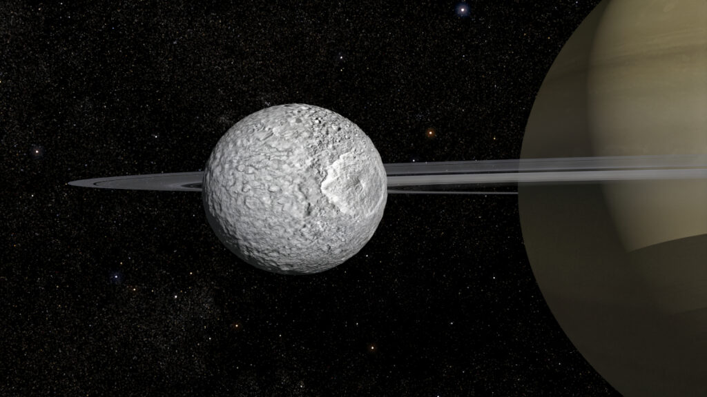 Gray and cratered Mimas hovers in front of Saturn with its rings seen edge on.