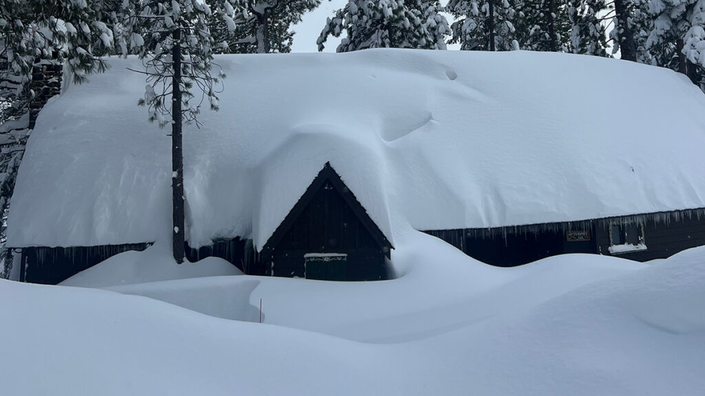 A house covered in several feet of snow