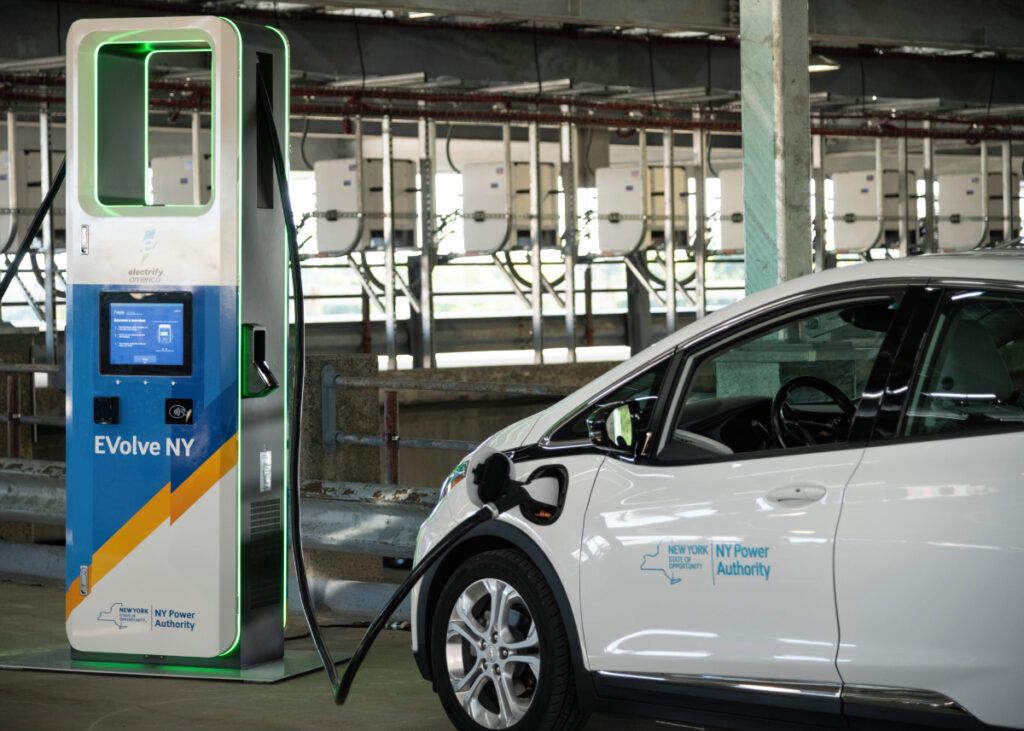 A white electric car charging.