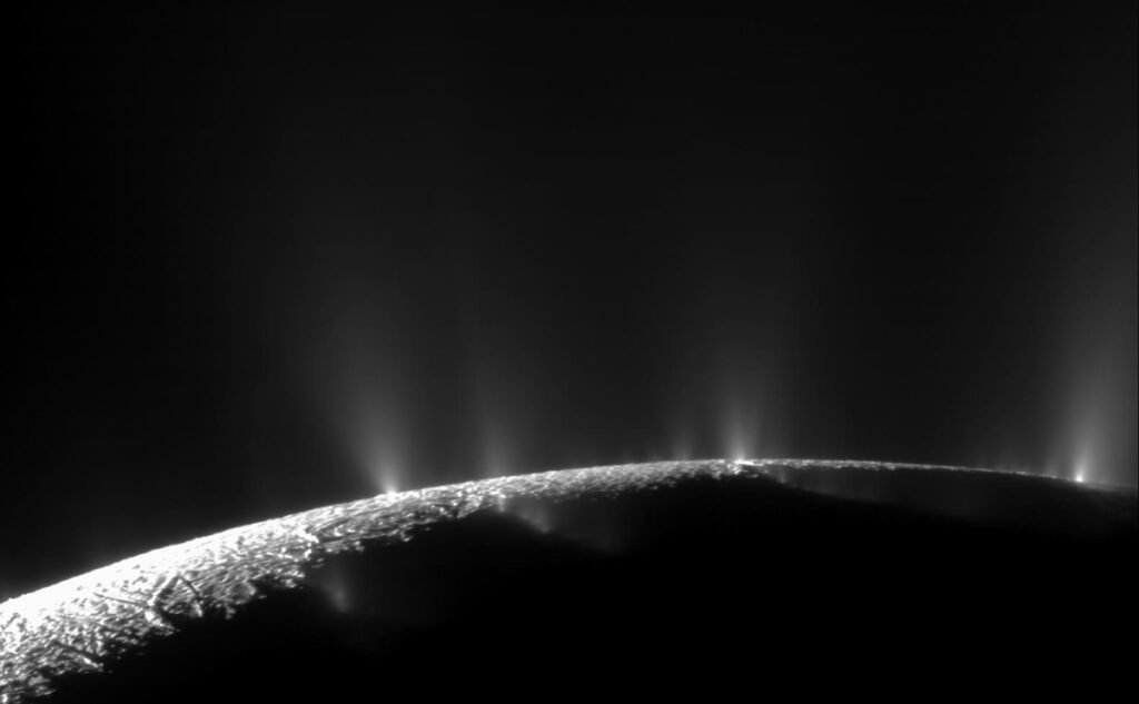 Enceladus’s horizon with four visible jets of material venting to space.