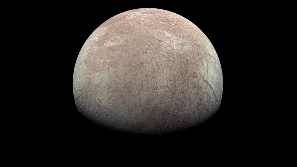 A white and tan moon covered with streaks of tan