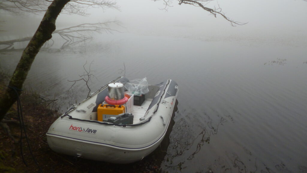 A boat holding an instrument on a foggy lake