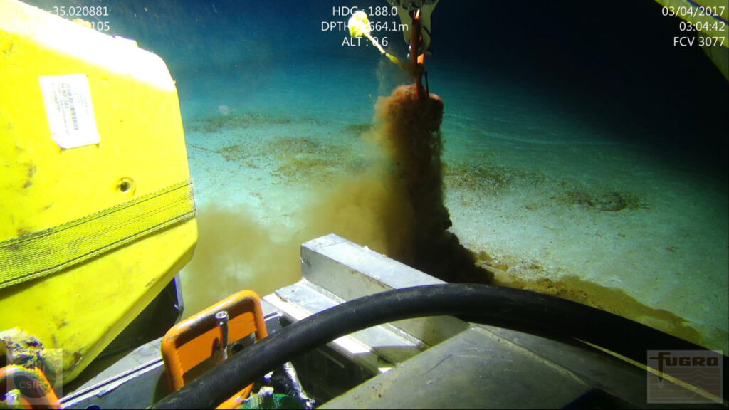 A submersible dredges sediment from the seafloor.