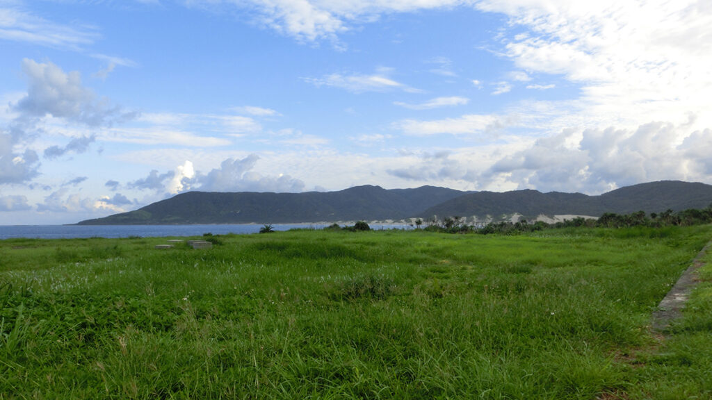 A mountain in the distance next to a body of water