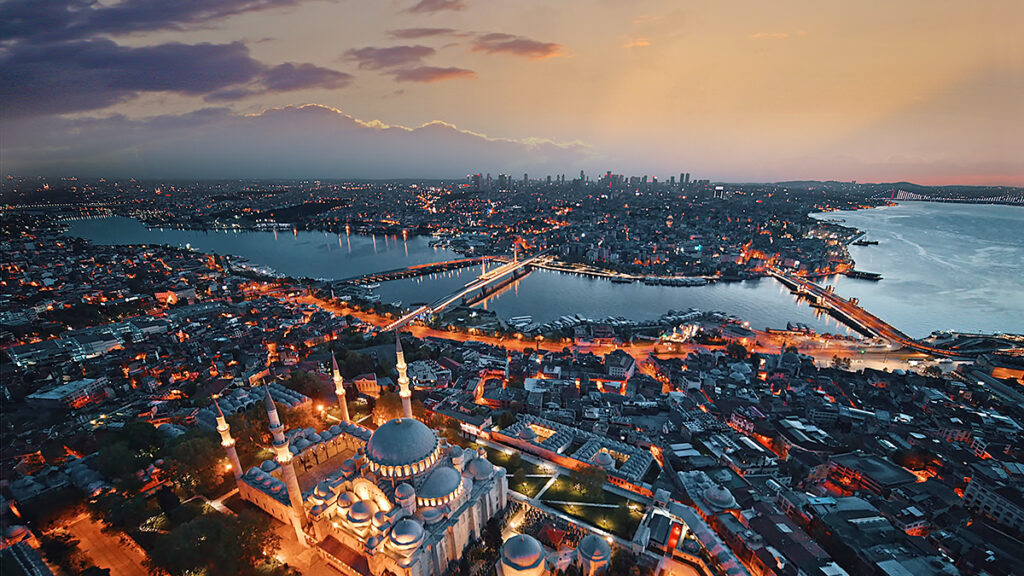 Aerial view overlooking the Süleymaniye Mosque (foreground), the Golden Horn inlet, and other parts of Istanbul, Türkiye, at dawn