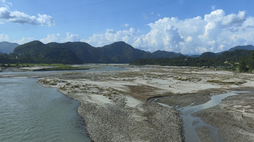 Part of the Madi River in Nepal, with forested mountains in the distance