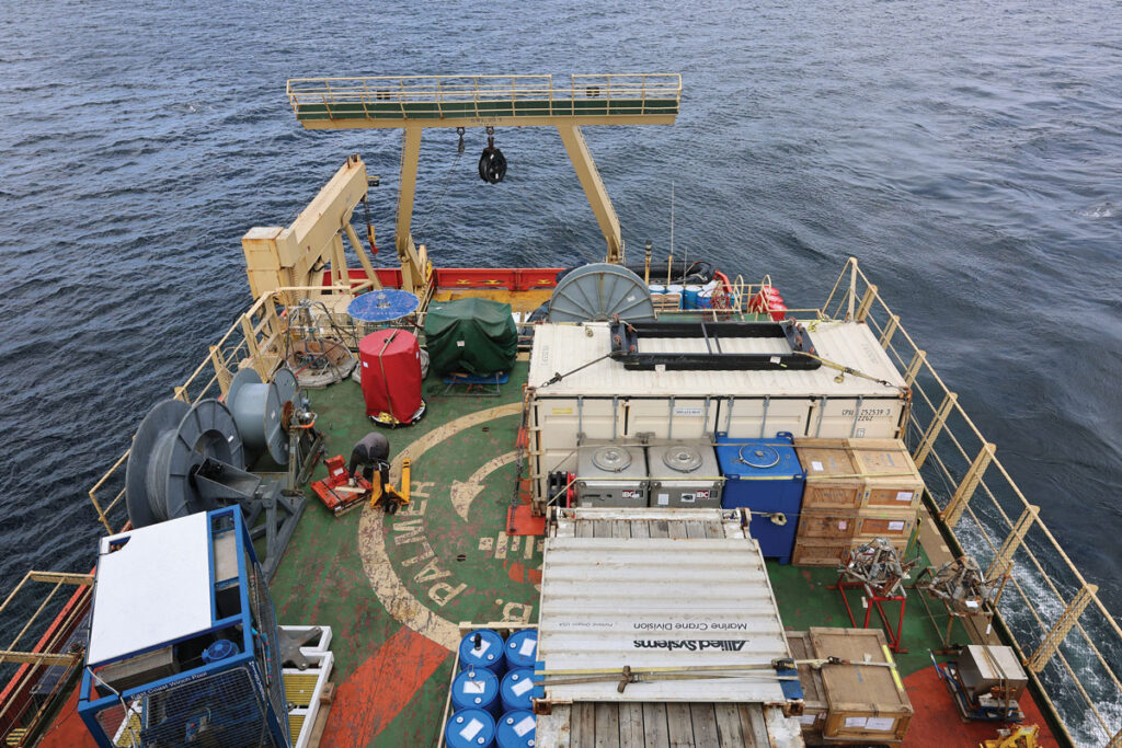 Boxes, crates, and barrels of scientific equipment crowd the deck of the R/V Nathaniel B. Palmer.
