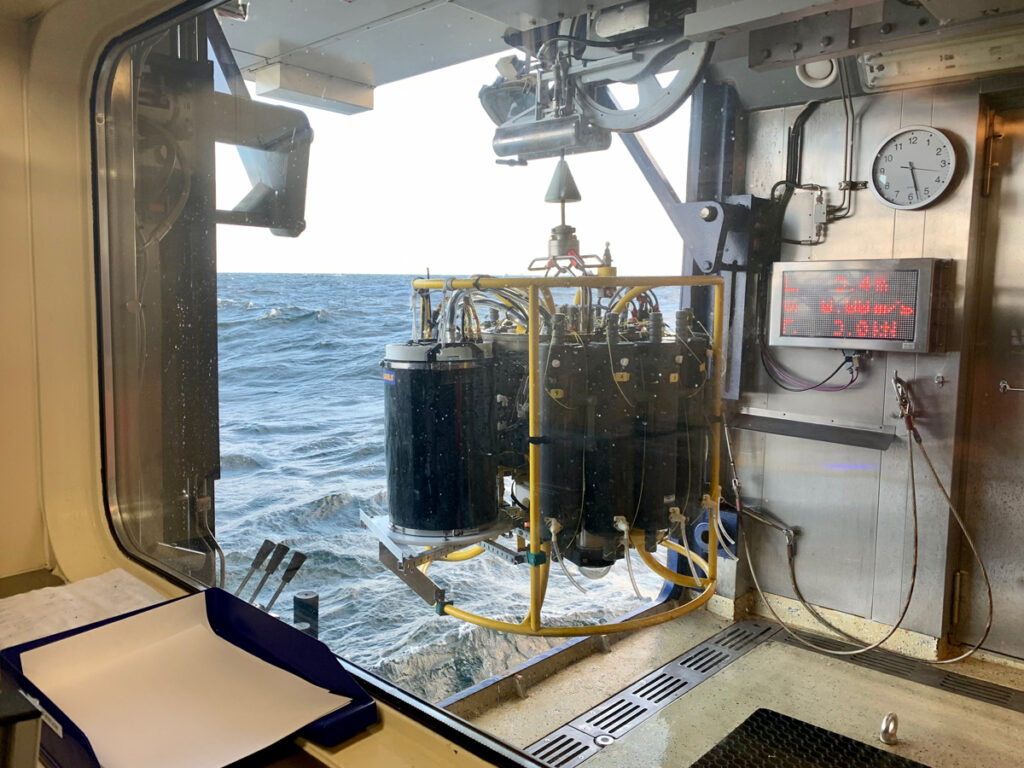 A cluster of cylinders is poised to be lowered over the side of a boat into the Baltic ocean to collect samples.
