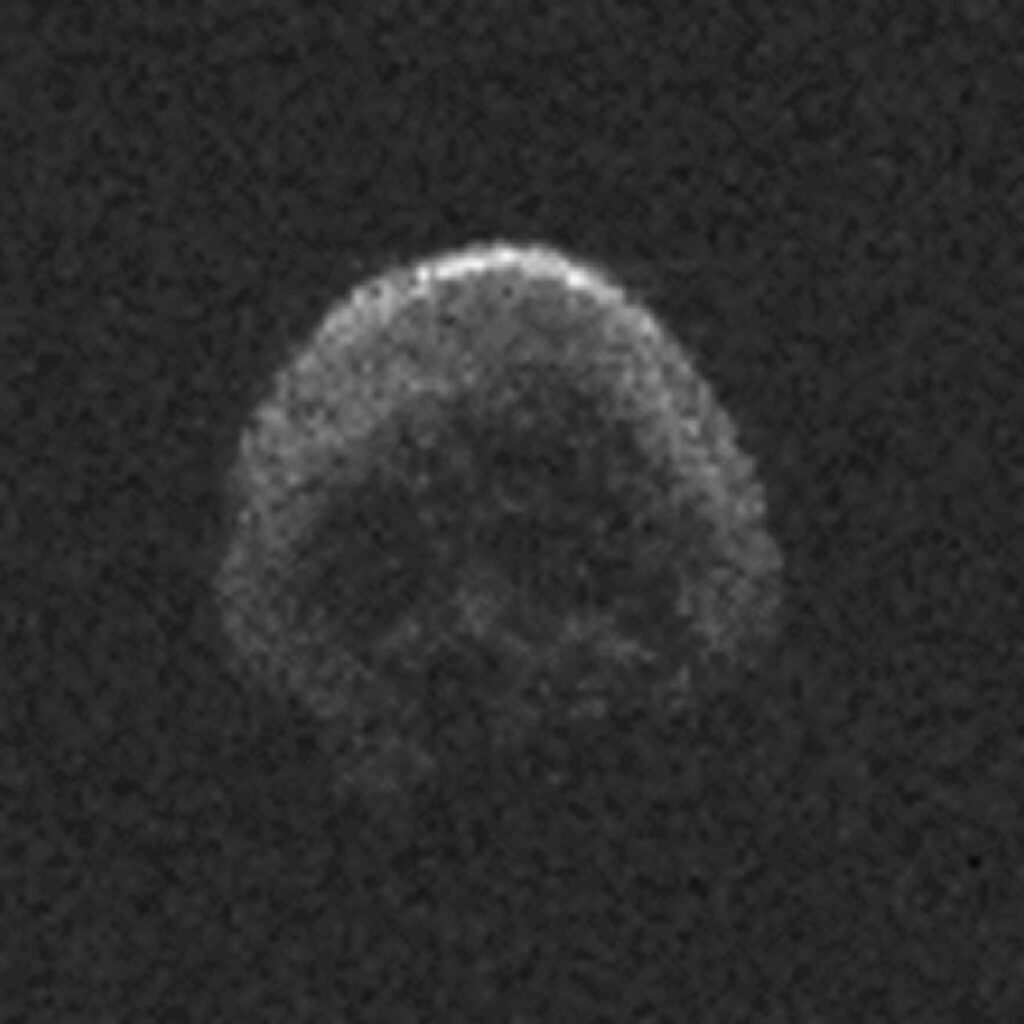 Pixelated image of an asteroid that looks remarkably like a human skull.