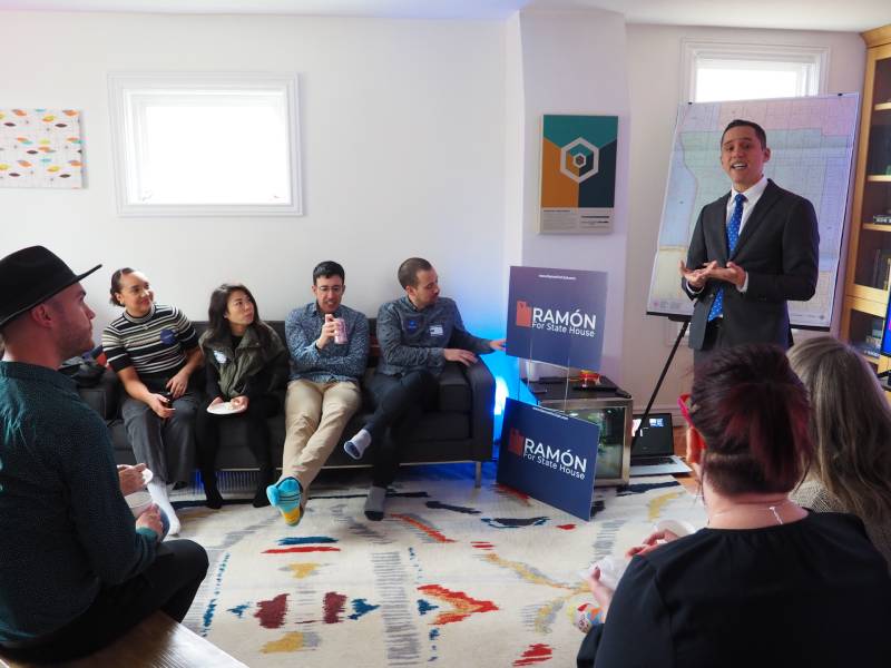 Ramón Barthelemy stands in front of a legislative map of Utah and speaks to a group of voters.
