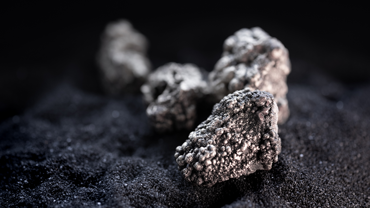 Photo of rare earths on black sand