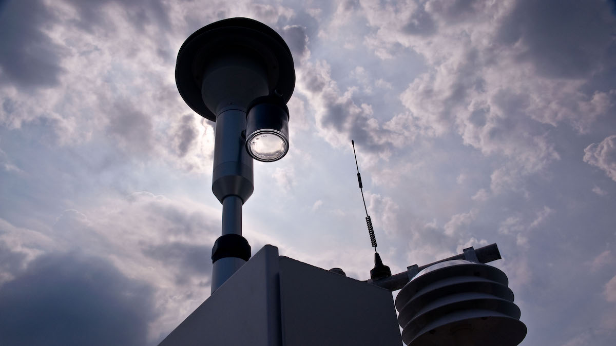 An air monitor seen against a cloudy sky.