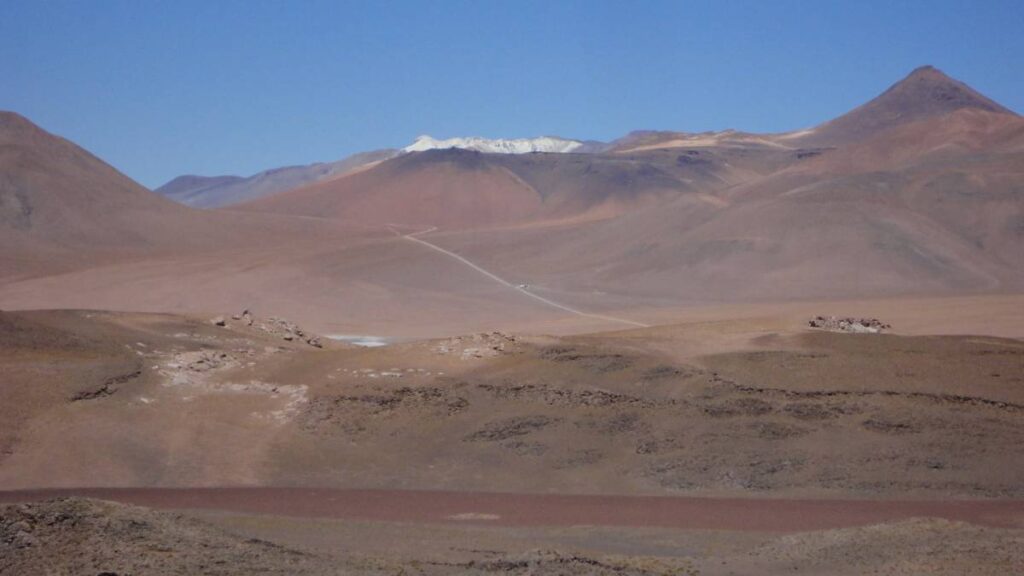 A desert mountain range at a distance.