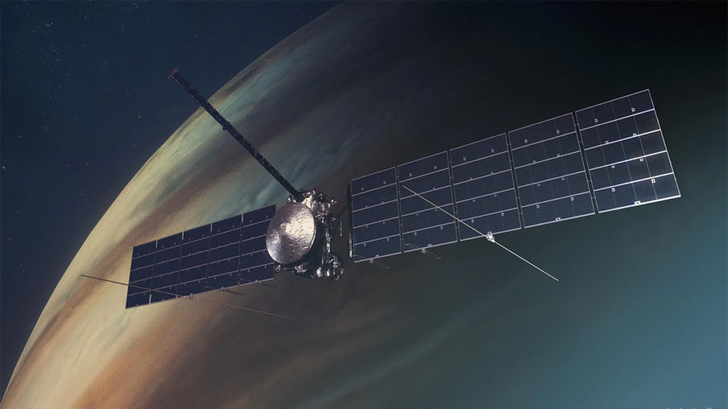 Spacecraft with large solar panels flies in front of Jupiter