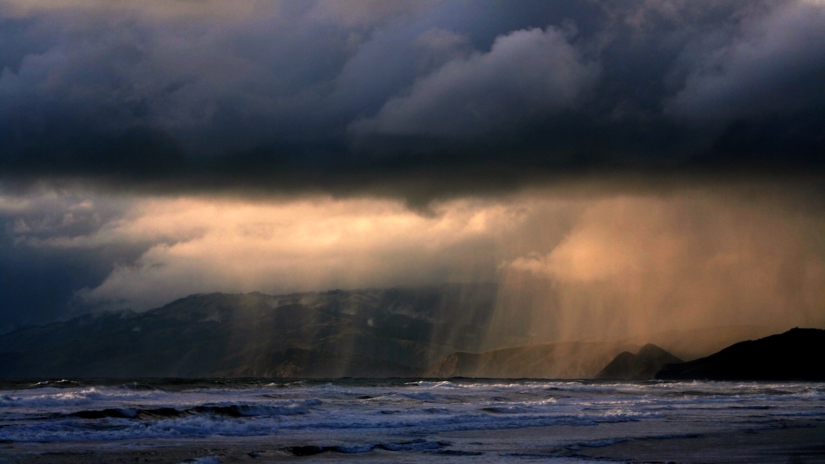 A cloudy sky and rain over Ocean Beach in San Francisco.