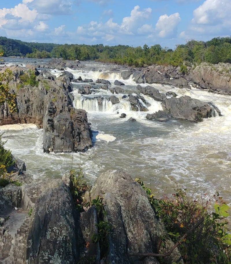 A raging river with rocky rapids and waterfalls.