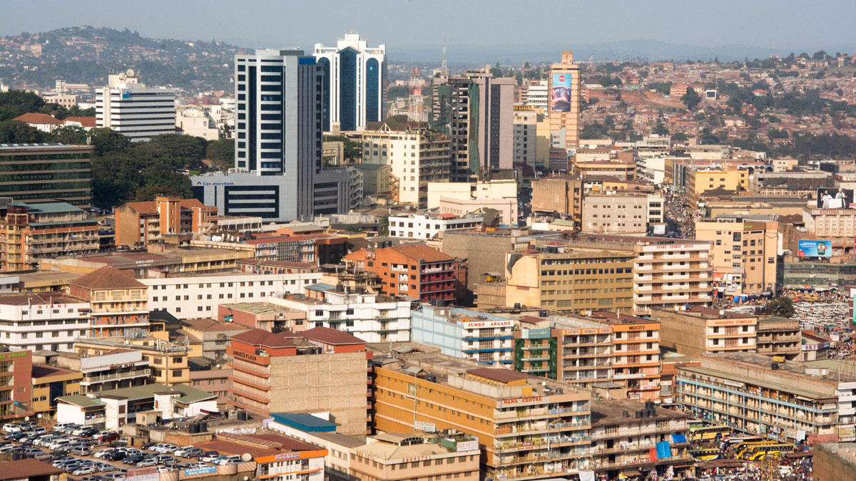 View of a dense city with buildings on hills in the background.