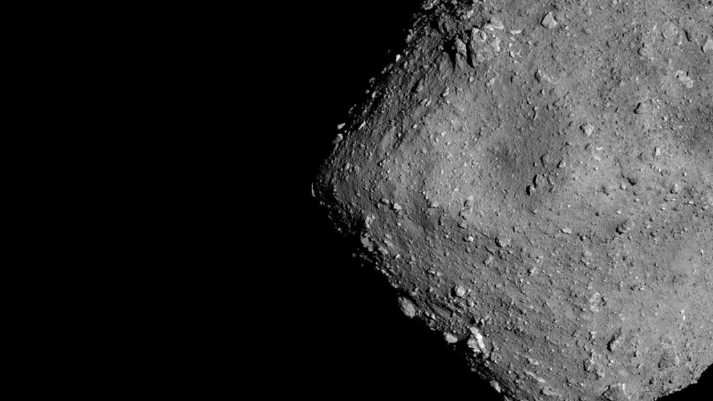 The grayscale surface of an asteroid with many boulders